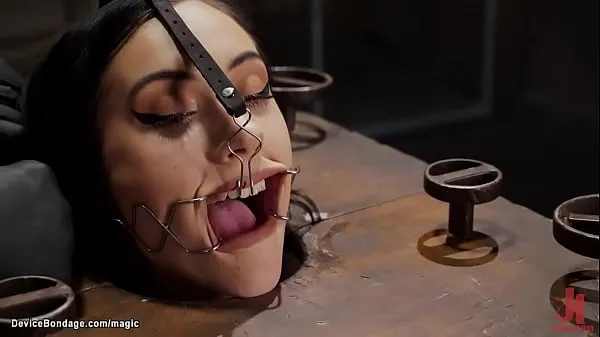 XXX Brunette slave Jazmin Luv is trapped in bondage cube with neck trapped in hole gets nipples clamped then bent over fucked with dildo o na stick by master The Pope posnetki Posnetki